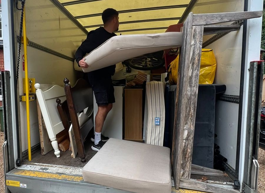 Witchard loading beds, mattresses and furniture into the van during a house clearance